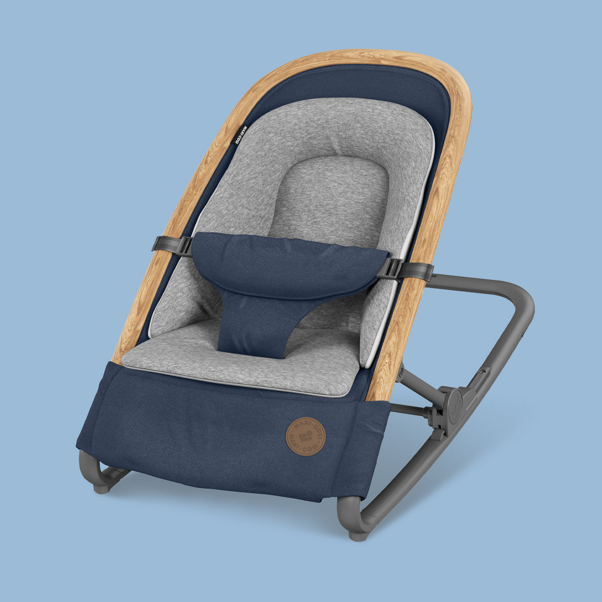 A relaxing blue and grey Maxi-Cosi UAE Kori Rocker on a blue background.