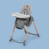 A Maxi-Cosi Minla Baby High Chair on a blue background.