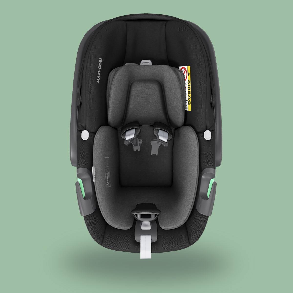 A safe Maxi-Cosi Pebble 360 baby car seat with a green background.