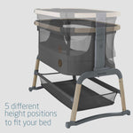 Baby crib with height adjustment features on a light gray background