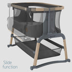 Maxi-Cosi baby crib with slide function on a light gray background
