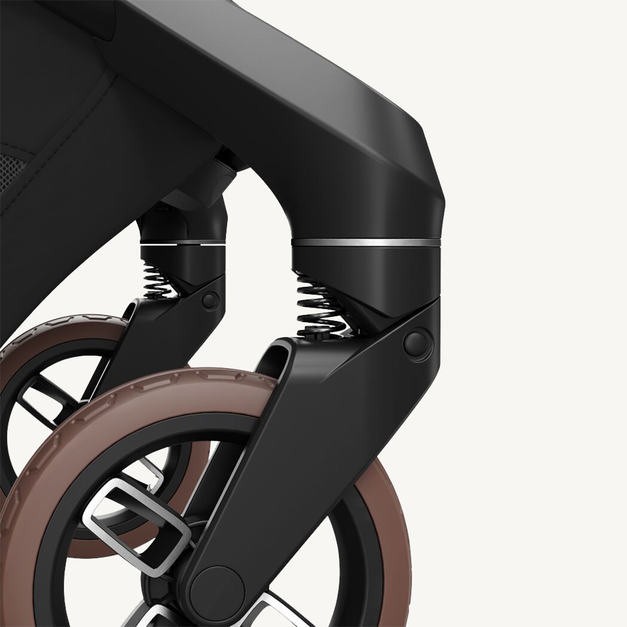 Close-up of a stroller wheel and suspension mechanism on a white background