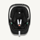 Front view of a black Maxi-Cosi Pebble 360 Pro² baby car seat with white harness straps on a light cream background.