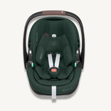 Front view of a dark green Maxi-Cosi Pebble 360 Pro² baby car seat with white harness straps on a light cream background.
