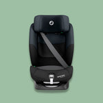 Black Maxi-Cosi car seat on a green background.